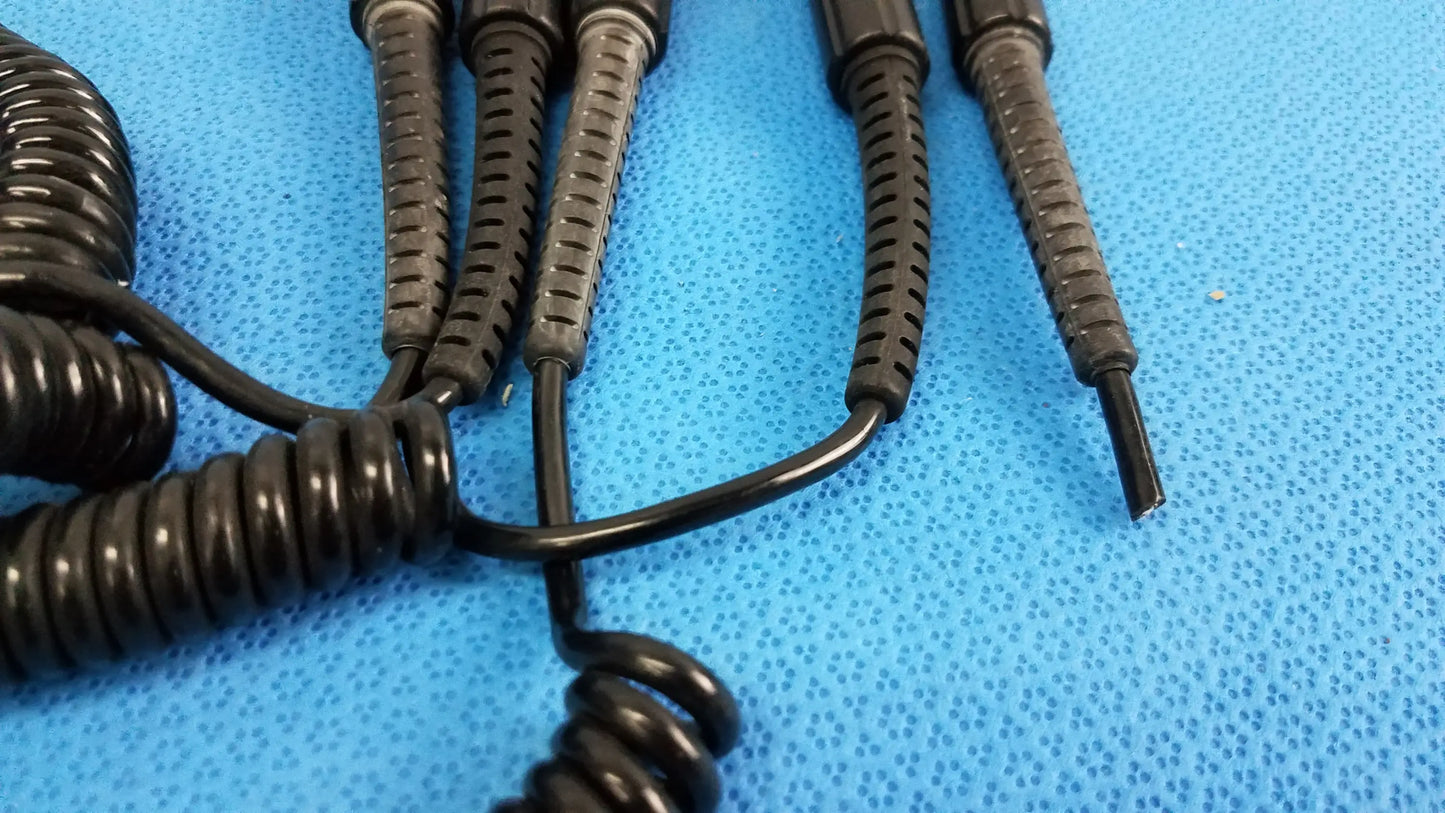 Black coiled cord with textured ribbed connectors for wall transformer ideal for reuse medical equipment applications