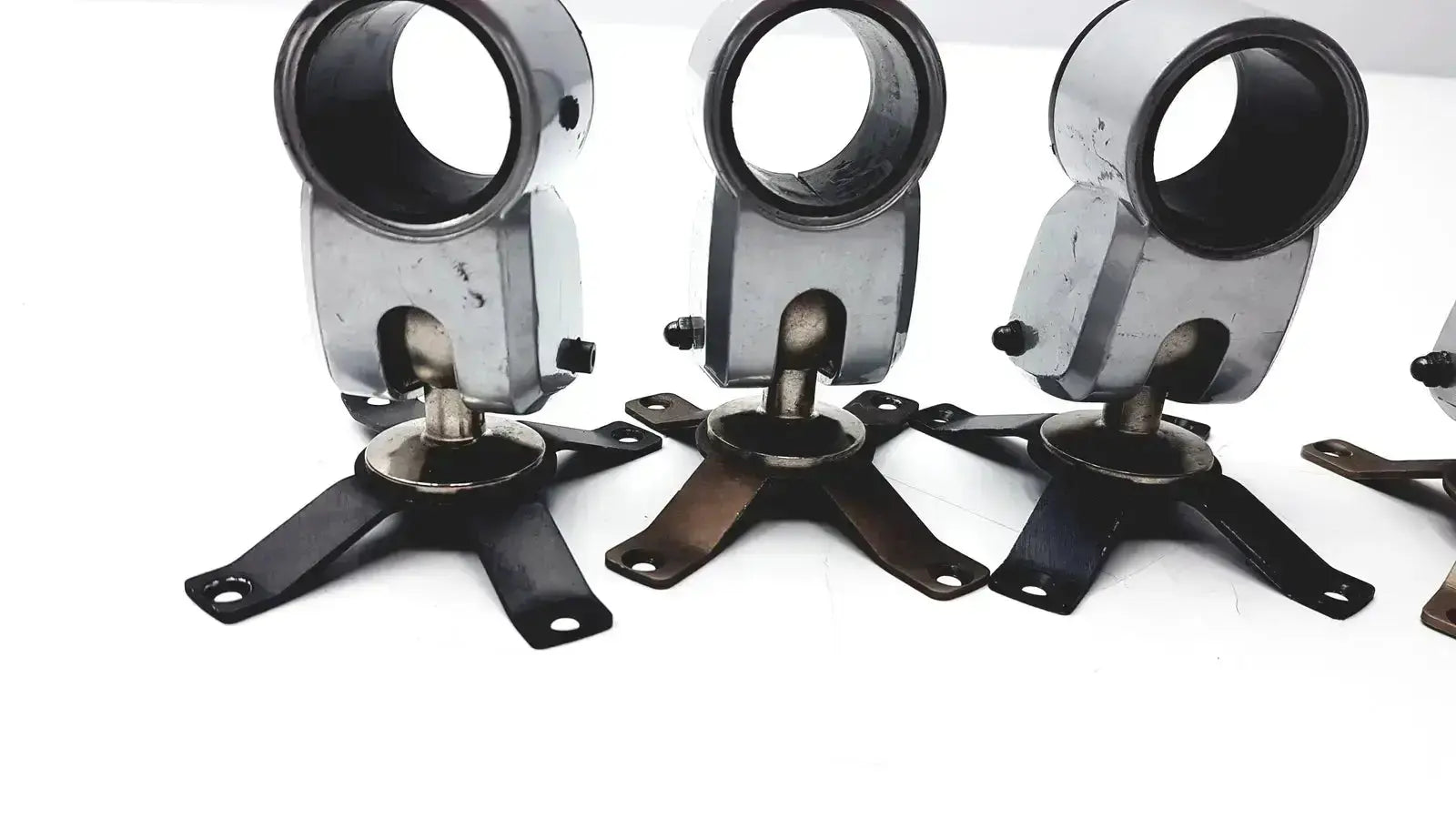 Lot of 5 black and silver metal clamps with circular upper section and four-legged base for hospital surplus equipment