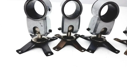Lot of 5 black and silver metal clamps with circular upper section and four-legged base for hospital surplus equipment