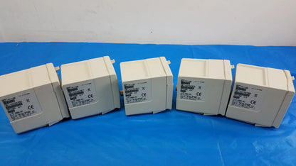 Five off-white plastic philips m1116b recorder modules arranged in a row for medical equipment patient monitoring