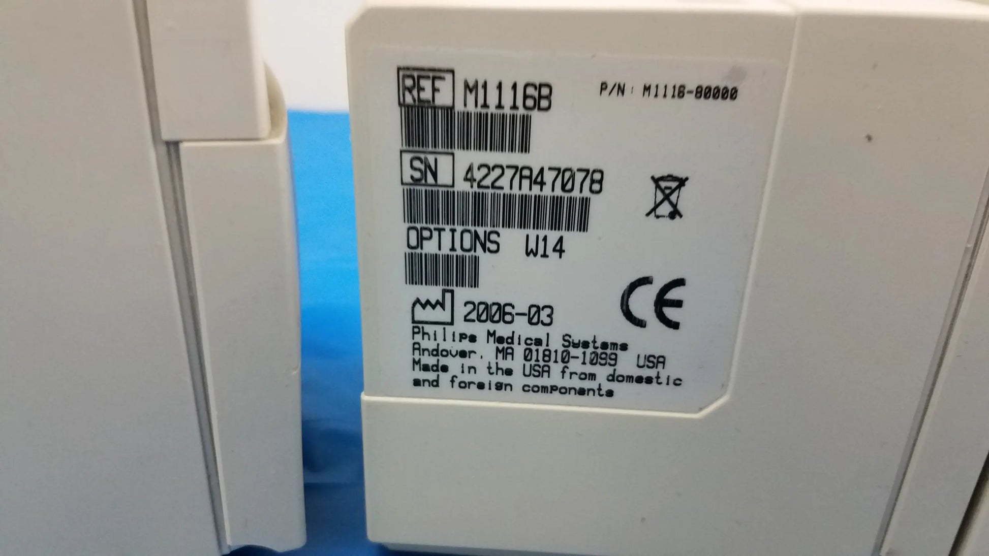 White plastic label with black text and barcodes on philips m1116b recorder module for medical equipment use