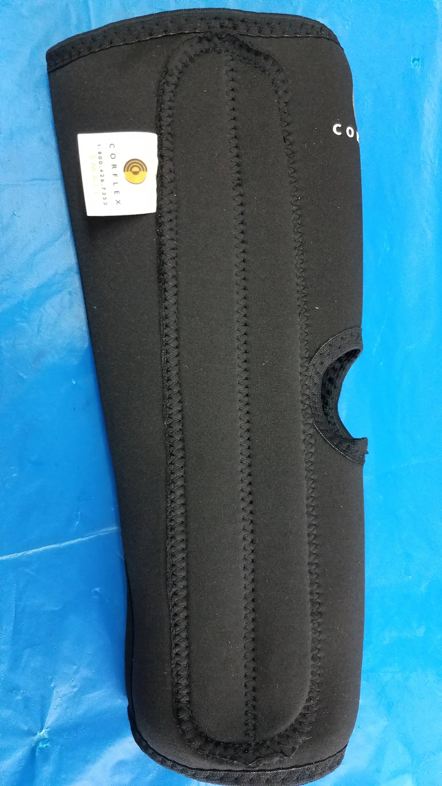 Black neoprene corflex cooltex knee sleeve with white label and gold logo for medical equipment use small size