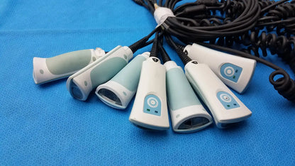Set of six light blue and white welch allyn handheld barcode scanners with coiled black cables for medical use
