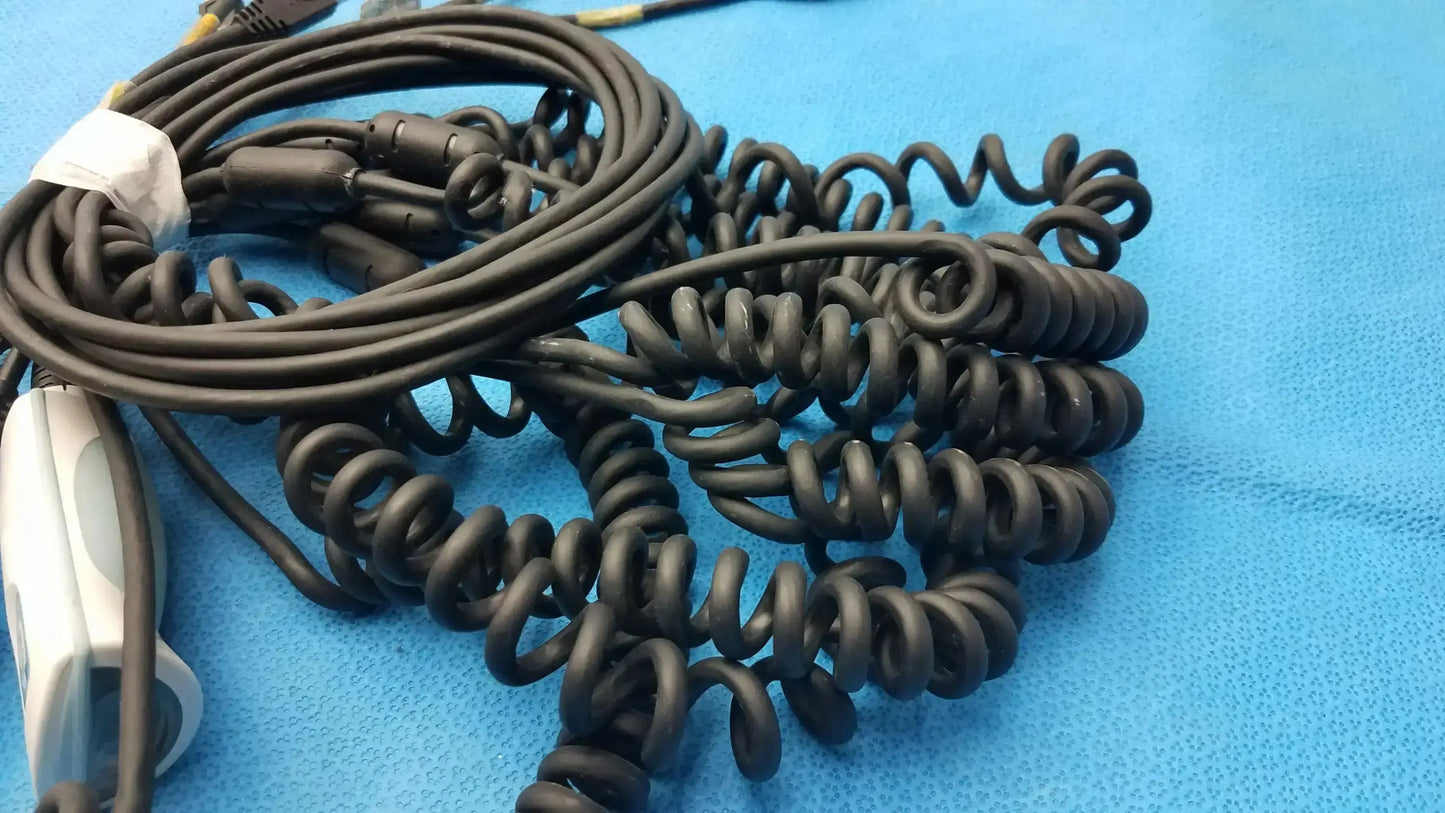 Black coiled cable attached to a white and gray welch allyn handheld barcode scanner for medical use