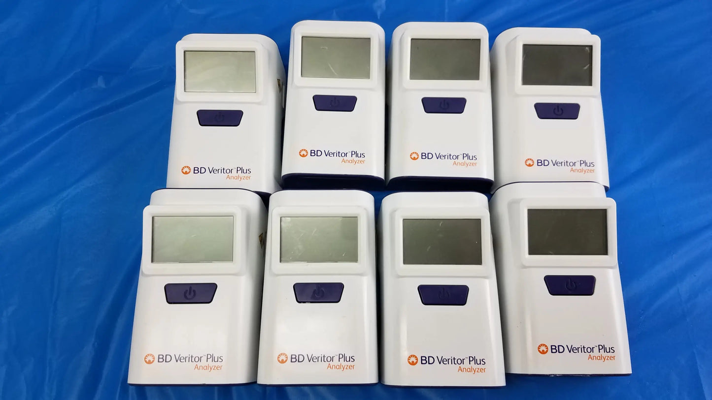 Lot of 8 white bd veritor plus analyzer medical equipment devices with purple buttons and screens arranged in two rows