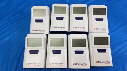 Lot of 8 white bd veritor plus analyzer medical equipment devices with purple buttons and screens arranged in two rows