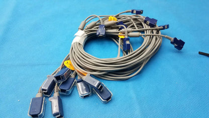Lot of 8 coiled gray nellcor doc-10 spo2 adapter extension cables with blue connectors and yellow identification tags