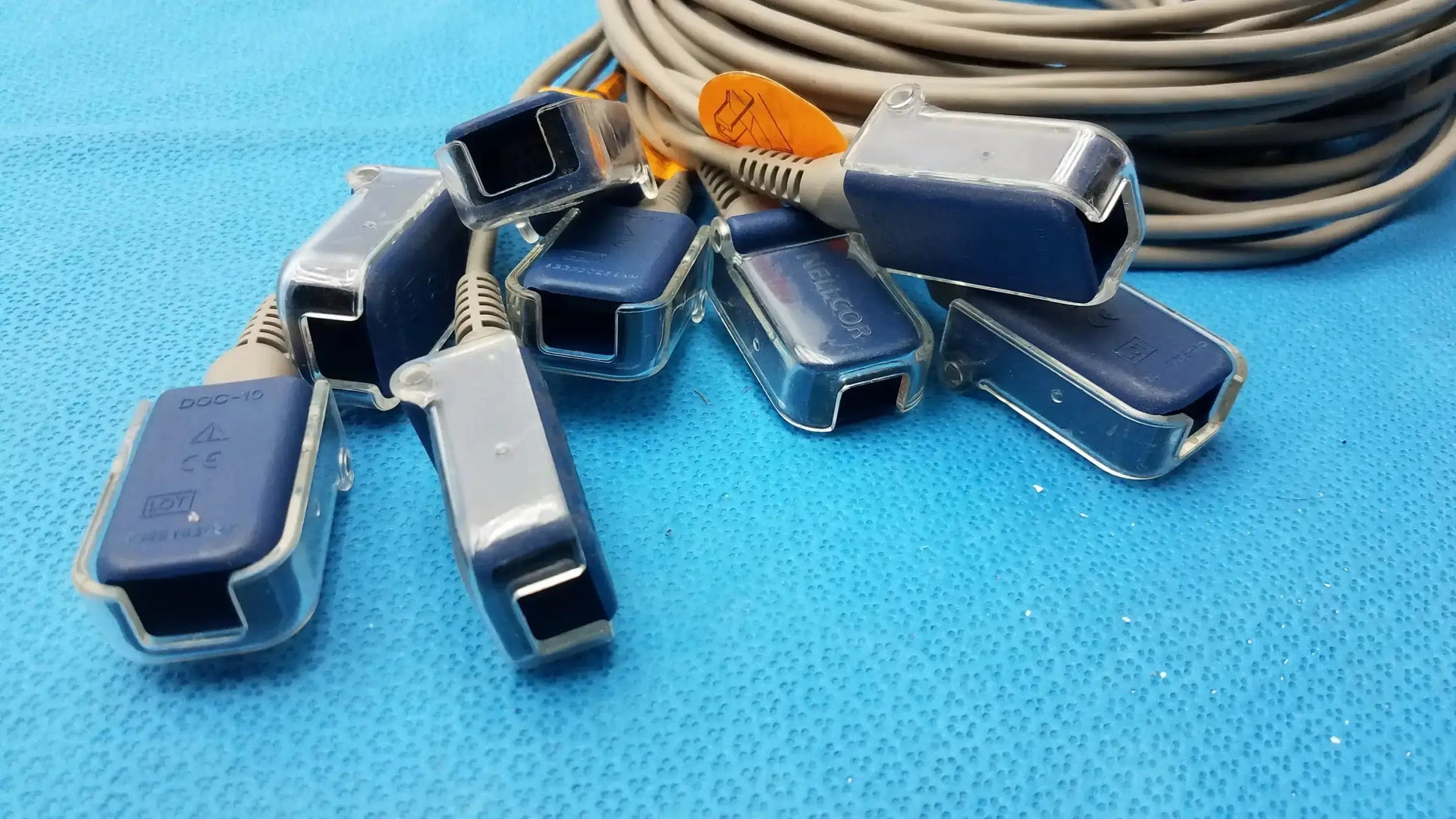 Lot of 8 nellcor doc-10 spo2 adapter extension cables featuring blue and clear plastic sensor connectors with gray cables