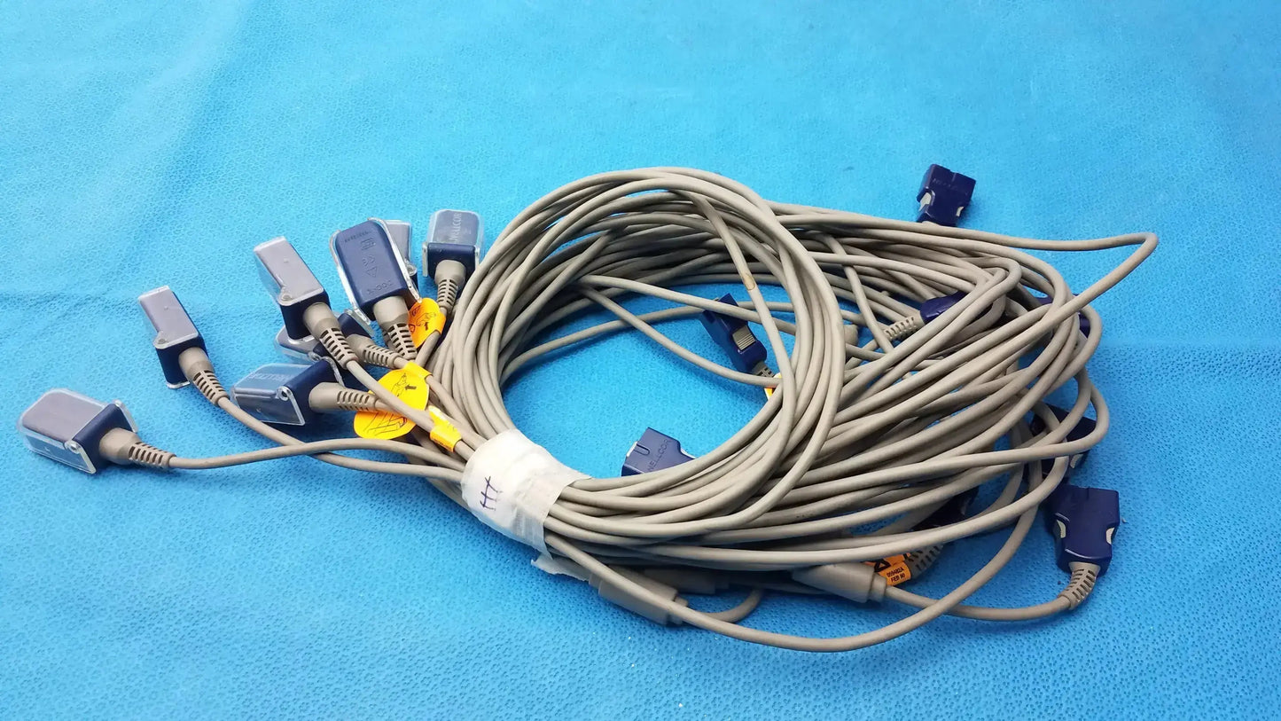Coiled beige Nellcor Doc-10 spo2 adapter extension cables with blue and gray connectors secured by a white tie