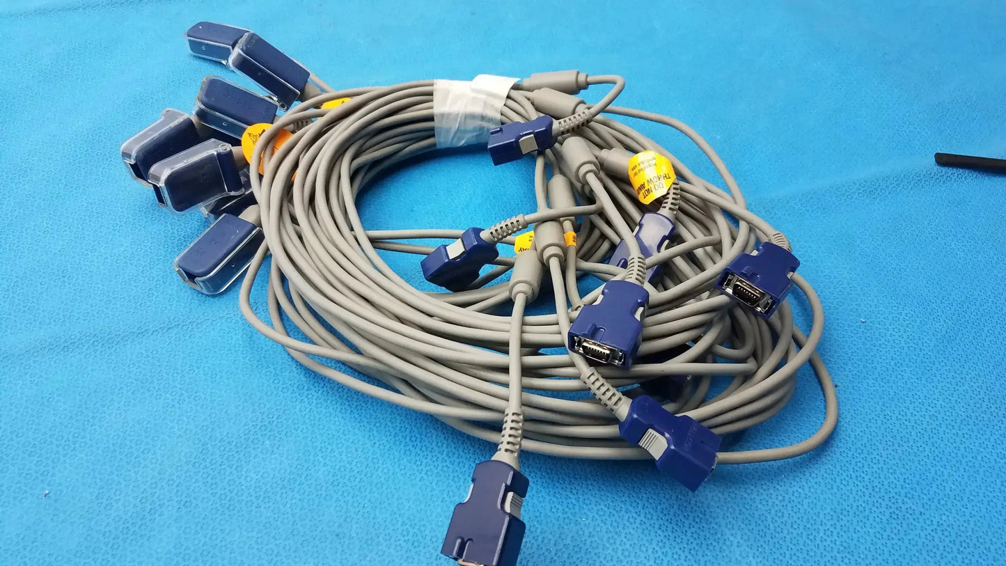 Lot of 8 coiled gray nellcor doc-10 spo2 adapter extension cables with blue connectors and yellow labels for medical monitoring