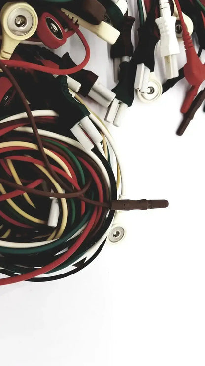 A tangle of multicolored insulated wires with red black alligator clips and white plugs for mix mindray compatible ecg leadwire