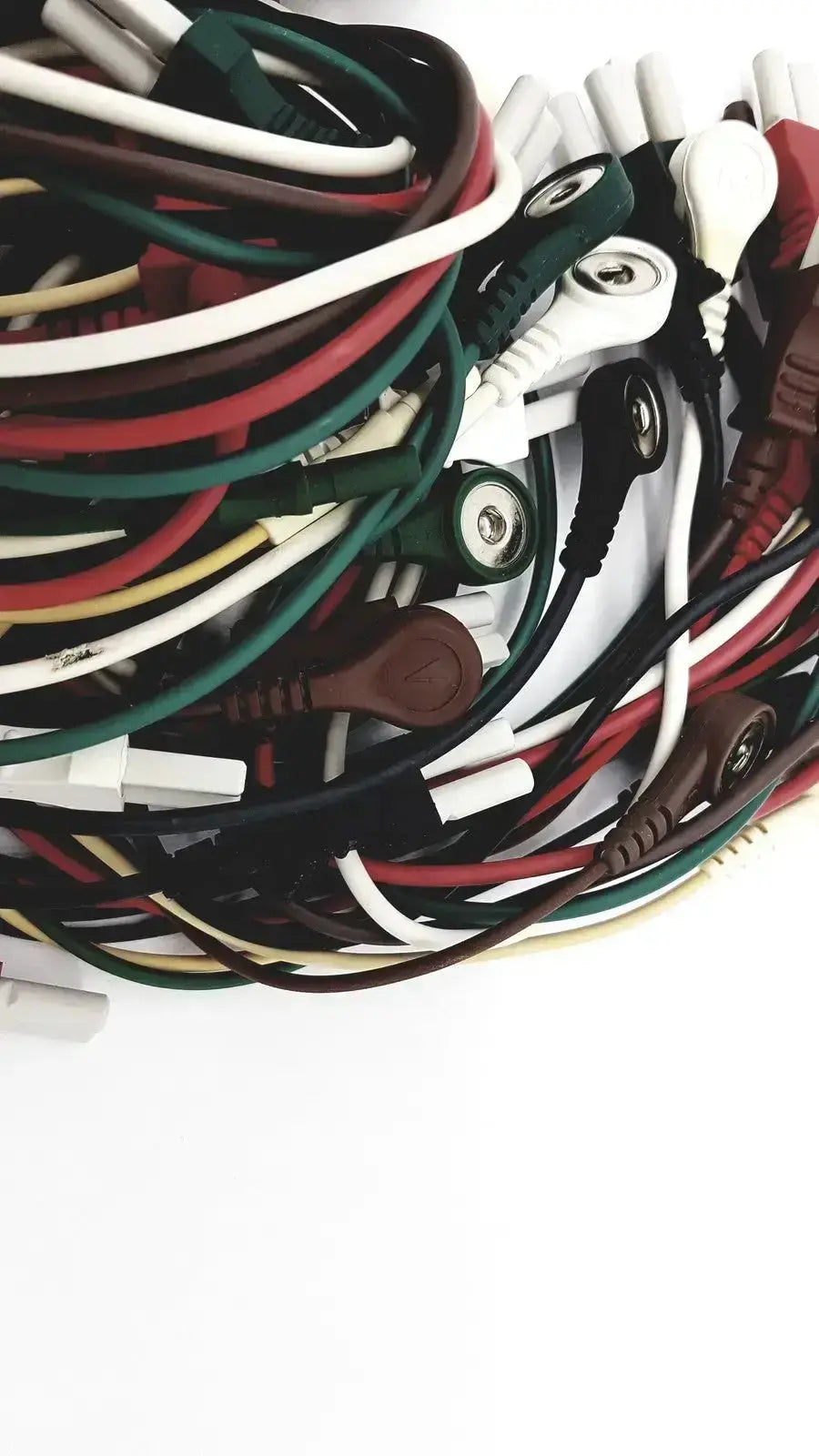 A tangle of mix mindray compatible ecg leadwires in white green red black and brown medical grade wires