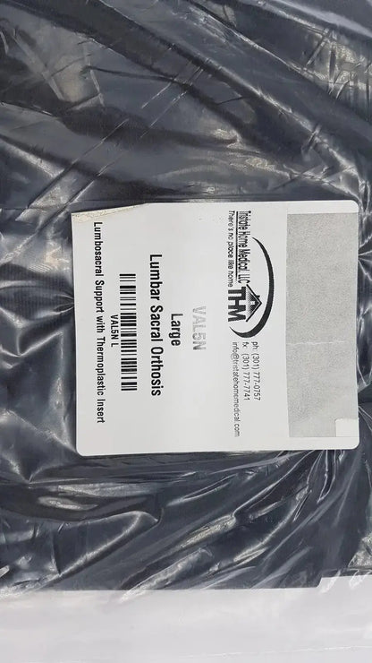 Black plastic-wrapped sacral orthosis val5n with white label featuring product details and branding large lumbosacral support