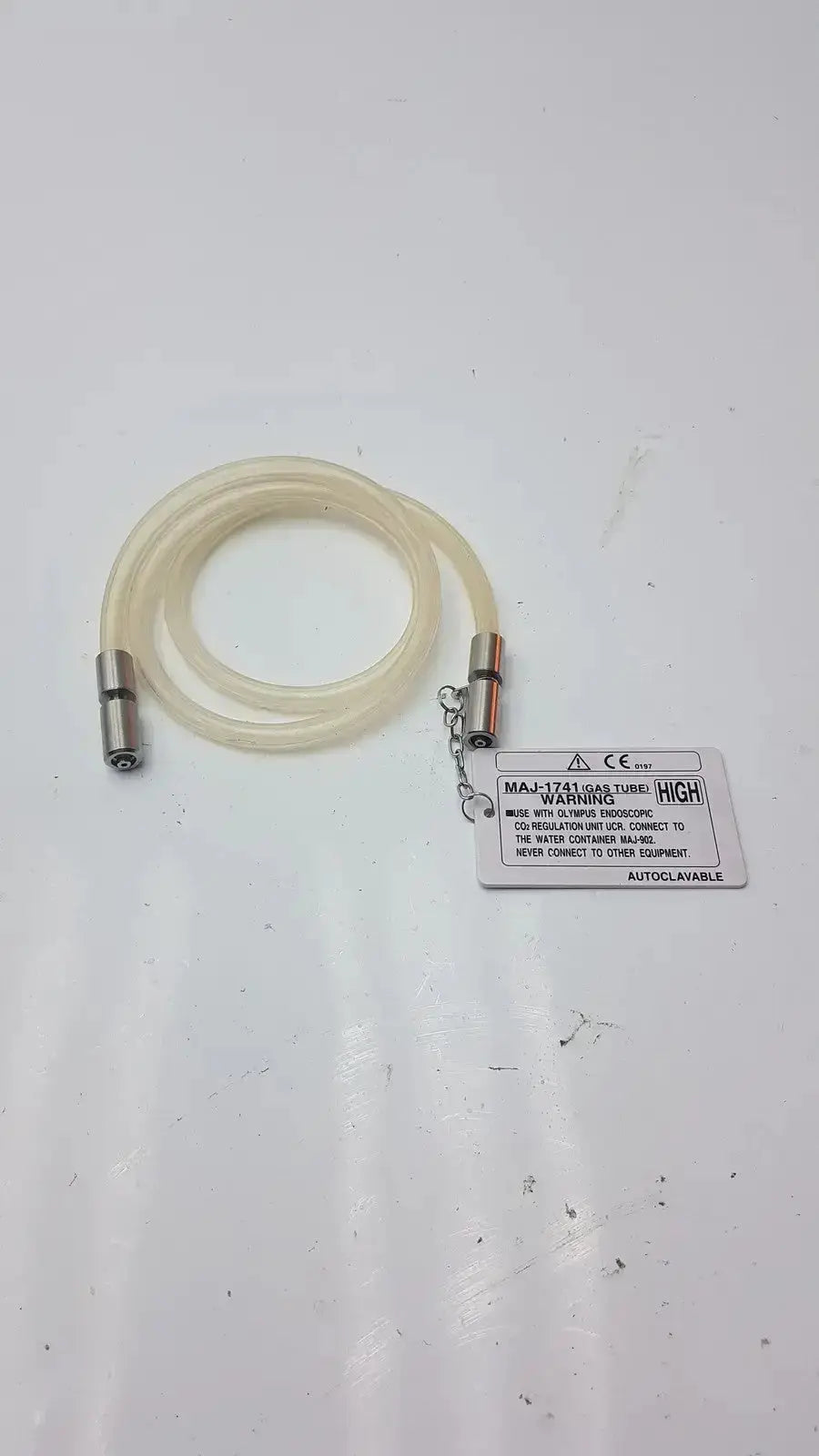 Clear flexible high-flow gas tube with metallic connectors and warning label for Olympus endoscopic CO2 regulation unit fit