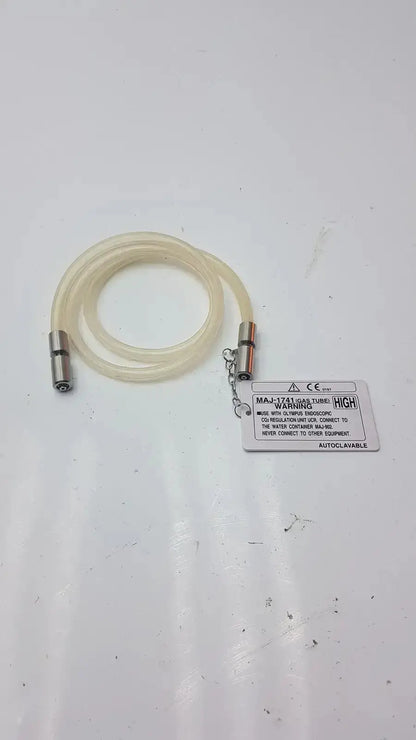 Clear flexible high-flow gas tube with metallic connectors and warning label for Olympus endoscopic CO2 regulation unit fit