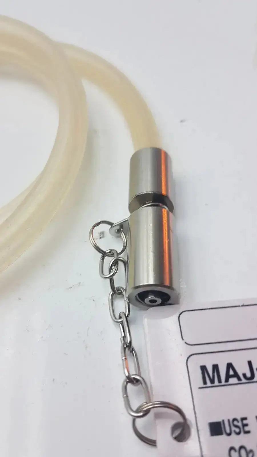 Silver metallic cylindrical valve with keyring connected to translucent tubing for olympus high-flow gas tube fit unit