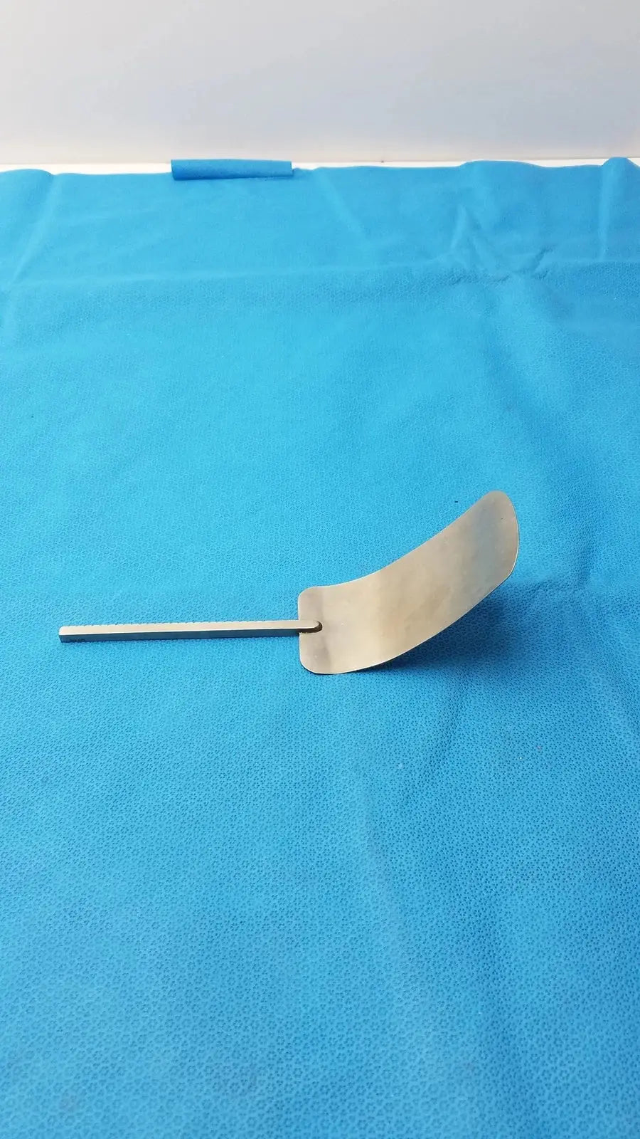 A sleek malleable retractor blade in polished stainless steel medical equipment for reuse in surgical procedures