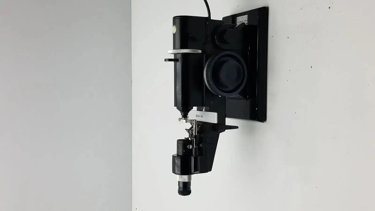 Black wall-mounted marco model 101 manual lensmeter with metallic accents and adjustable components for hospital surplus