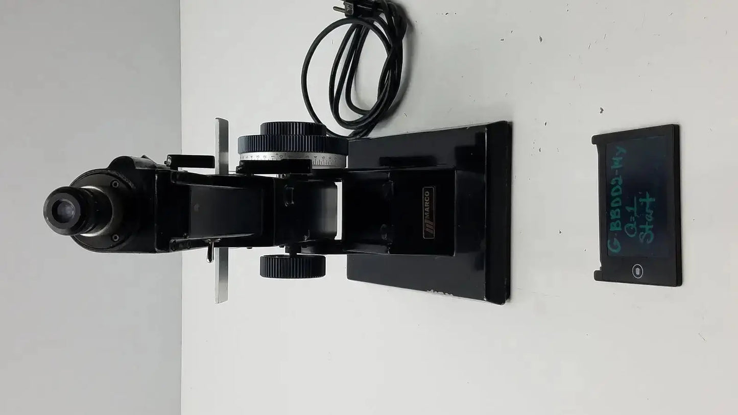 Black metal marco model 101 manual lensmeter with adjustable stage and objective lens for hospital surplus use