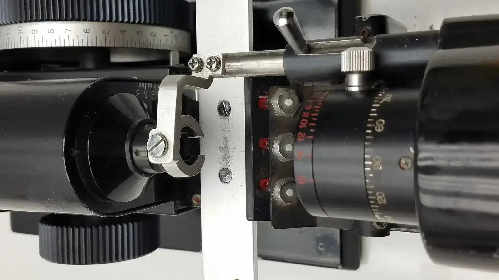 Black cylindrical marco model 101 manual lensmeter with silver adjustment knobs and red numerical markings for hospital surplus use