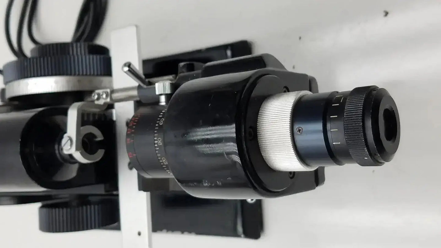 Black and silver microscope objective lens with knurled adjustment rings for marco model 101 manual lensmeter hospital surplus