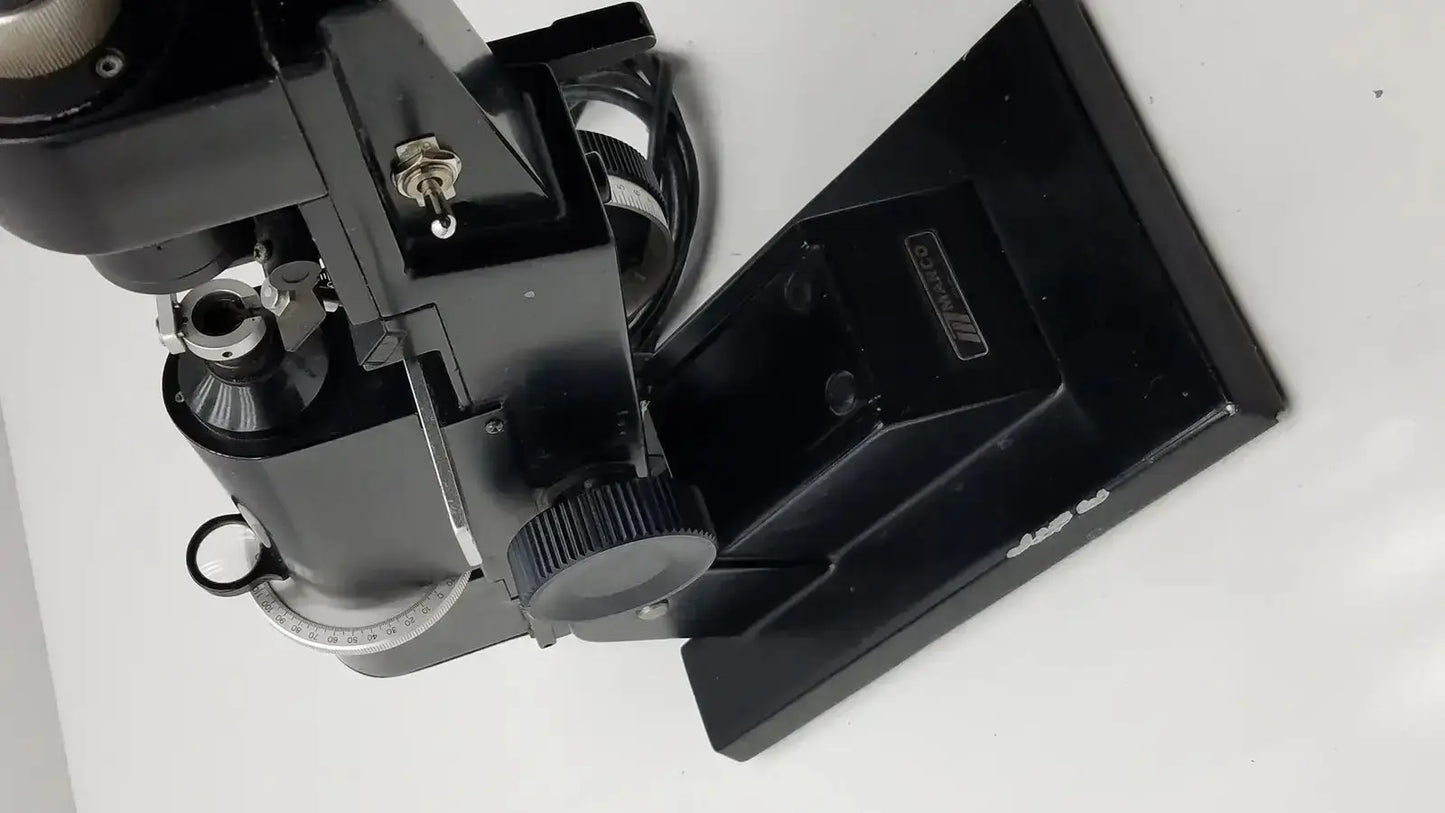 Black metal marco model 101 manual lensmeter with sturdy base and adjustable focus knobs from hospital surplus