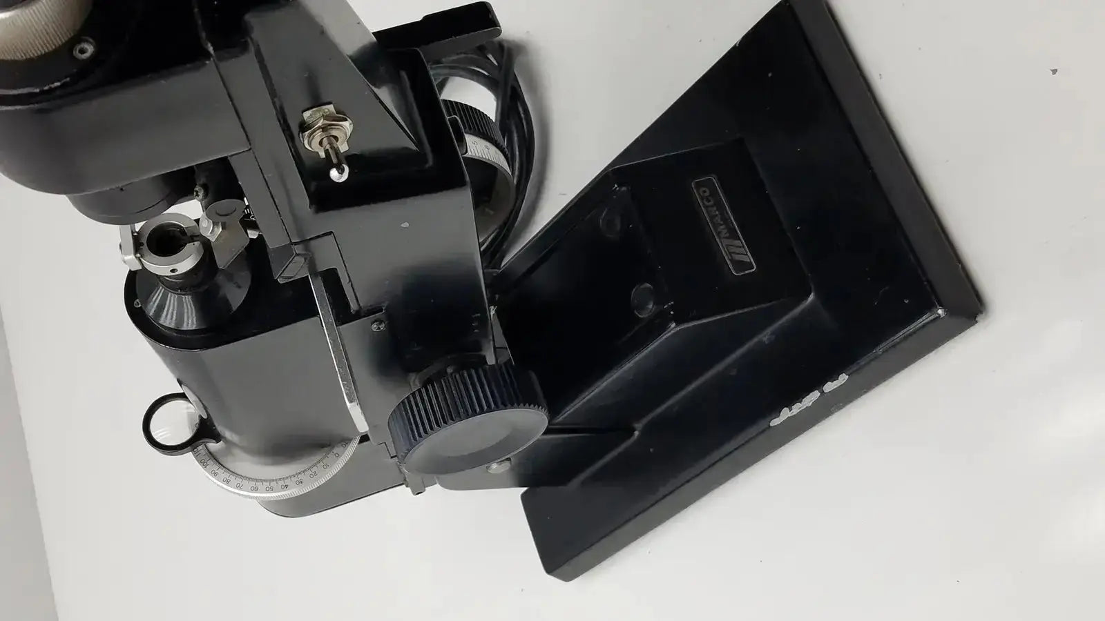 Black metal marco model 101 manual lensmeter with sturdy base and adjustable focus knobs from hospital surplus