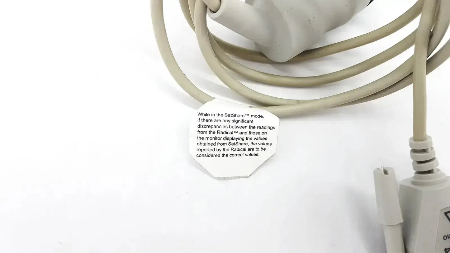 Beige coiled masimo d006 satshare interface cable with white label showing instructional text for medical use