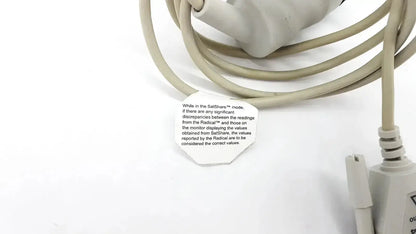Beige coiled masimo d006 satshare interface cable with white label showing instructional text for medical use