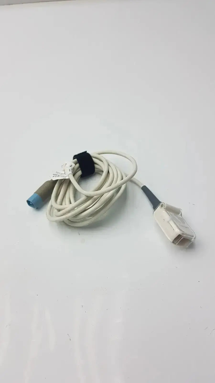 White coiled masimo ps-10153d cable interface with blue-tipped connector and gray-white plastic plug for medical use