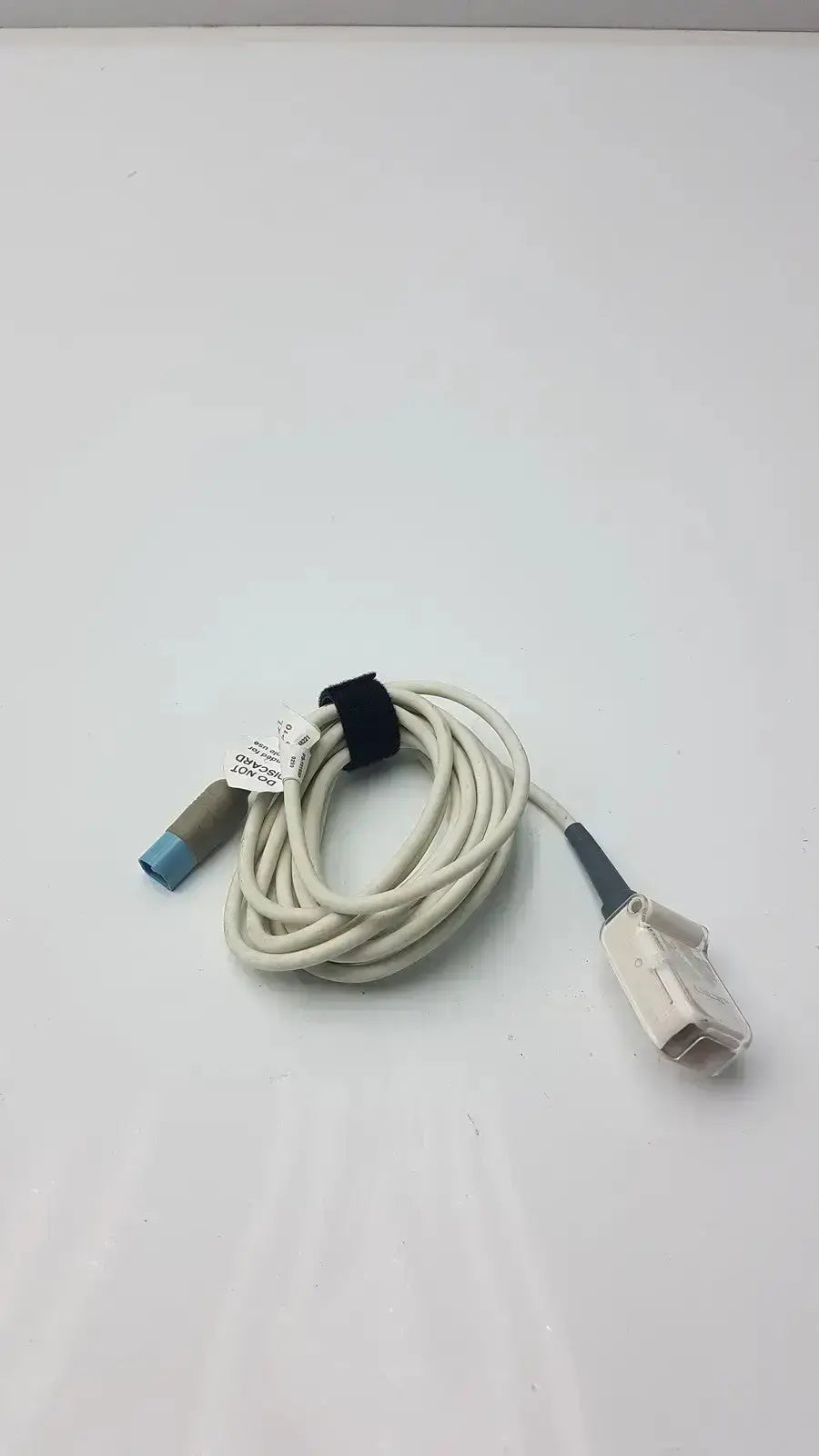 Beige coiled masimo ps-10153d cable interface with blue-tipped connector and gray-white plug secured by black strap