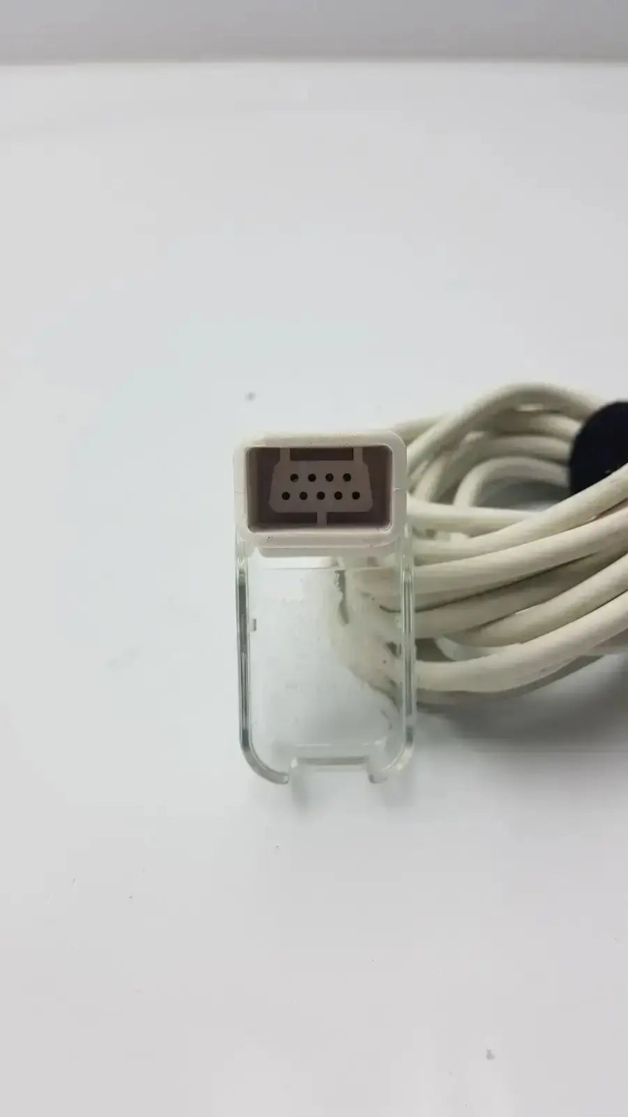 Clear plastic connector with beige 8-pin port attached to coiled white cable for masimo ps-10153d cable interface