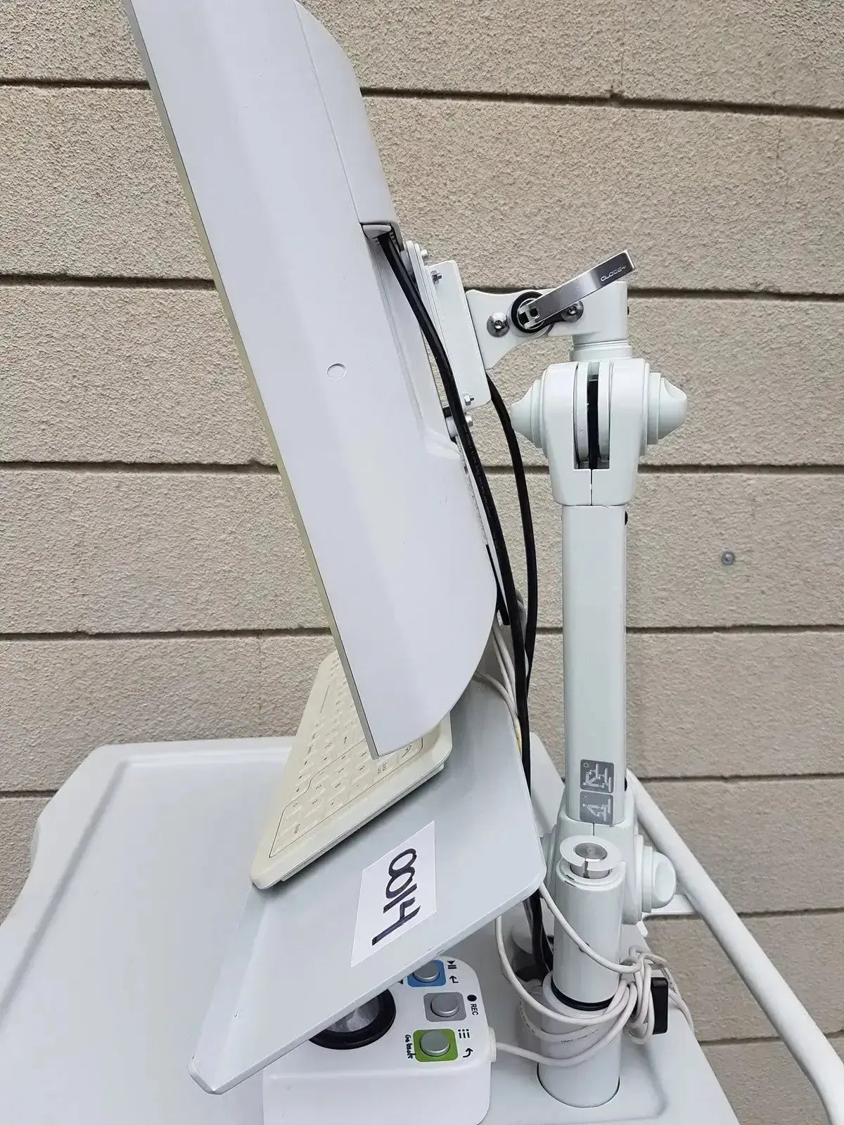 White adjustable monitor arm with sleek modern design holding upright computer screen for mauna kea technologies cellvizio f-400 v2 manometry system