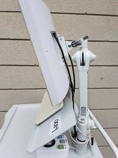White adjustable monitor arm with sleek modern design holding upright computer screen for mauna kea technologies cellvizio f-400 v2 manometry system