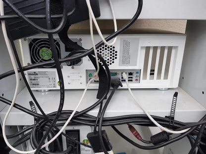 White computer tower with black cables and green fan on left side of mauna kea technologies cellvizio f-400 v2 manometry system