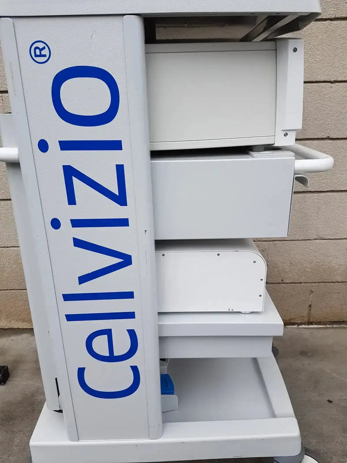 White cellvizio f-400 v2 manometry medical imaging cart with blue lettering and multiple drawers by mauna kea technologies