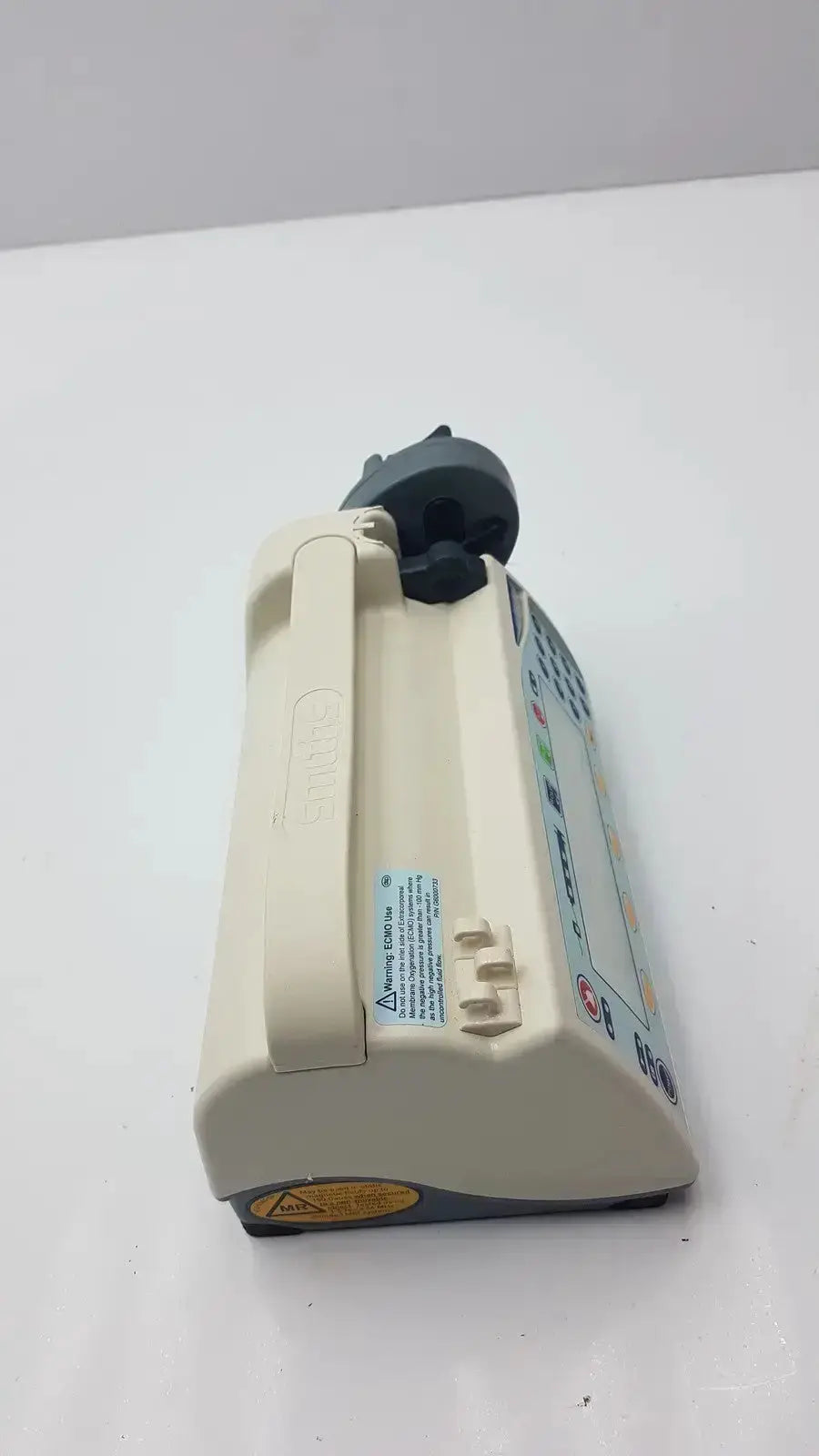 Beige medfusion 3500 medical infusion pump with dark gray control panel and pole clamp for hospital surplus biomedical evaluation