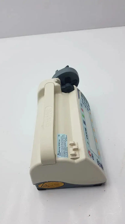 Beige medfusion 3500 medical infusion pump with dark gray control panel and pole clamp for hospital surplus biomedical evaluation
