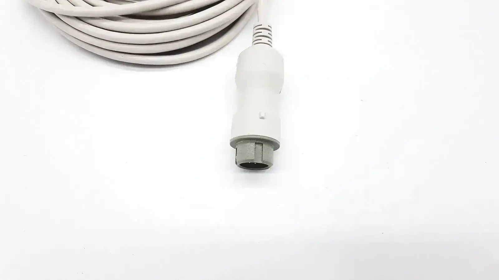 White medical reusable bare copper wire ibp cable with gray connector coiled neatly for mindray ibp cable use