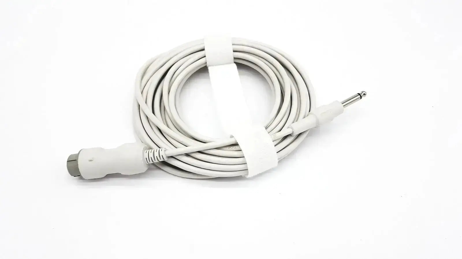 White coiled reusable bare copper wire ibp cable with gray connector and silver 6.35mm jack secured by white tie