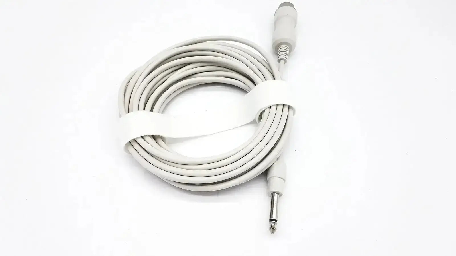 Gray coiled reusable bare copper wire ibp cable with white strap and metallic 6.35mm male and female jacks for medical use