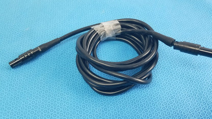 Black coiled medical surgical handpiece console extension cable with threaded metallic and smooth plastic connectors