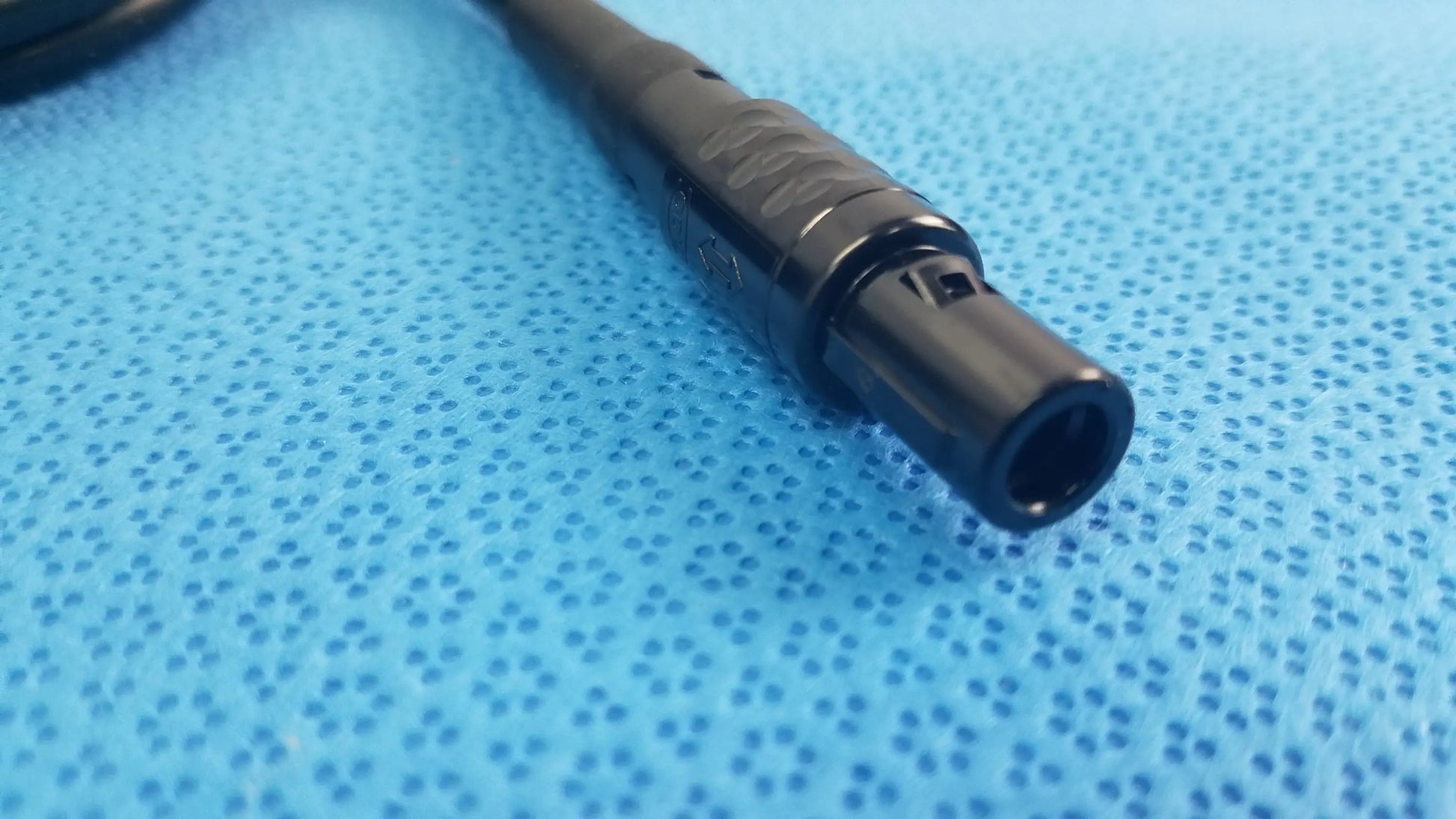 Black plastic xlr console extension cable connector with textured grip and threaded locking for surgical handpiece use in medical equipment