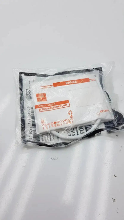 White and black blood pressure cuff in clear plastic packaging with orange labeling medline disposable cuff range 20.5 - 28.5 cm