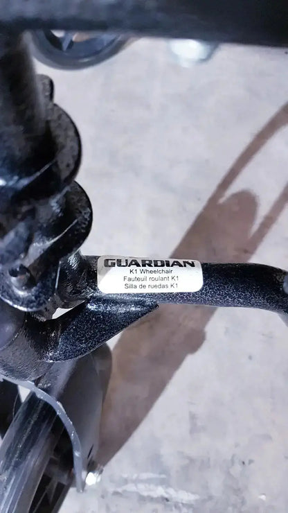 Black guardian k1 lightweight wheelchair compact wheel axle with matte finish and metallic components shown from back side