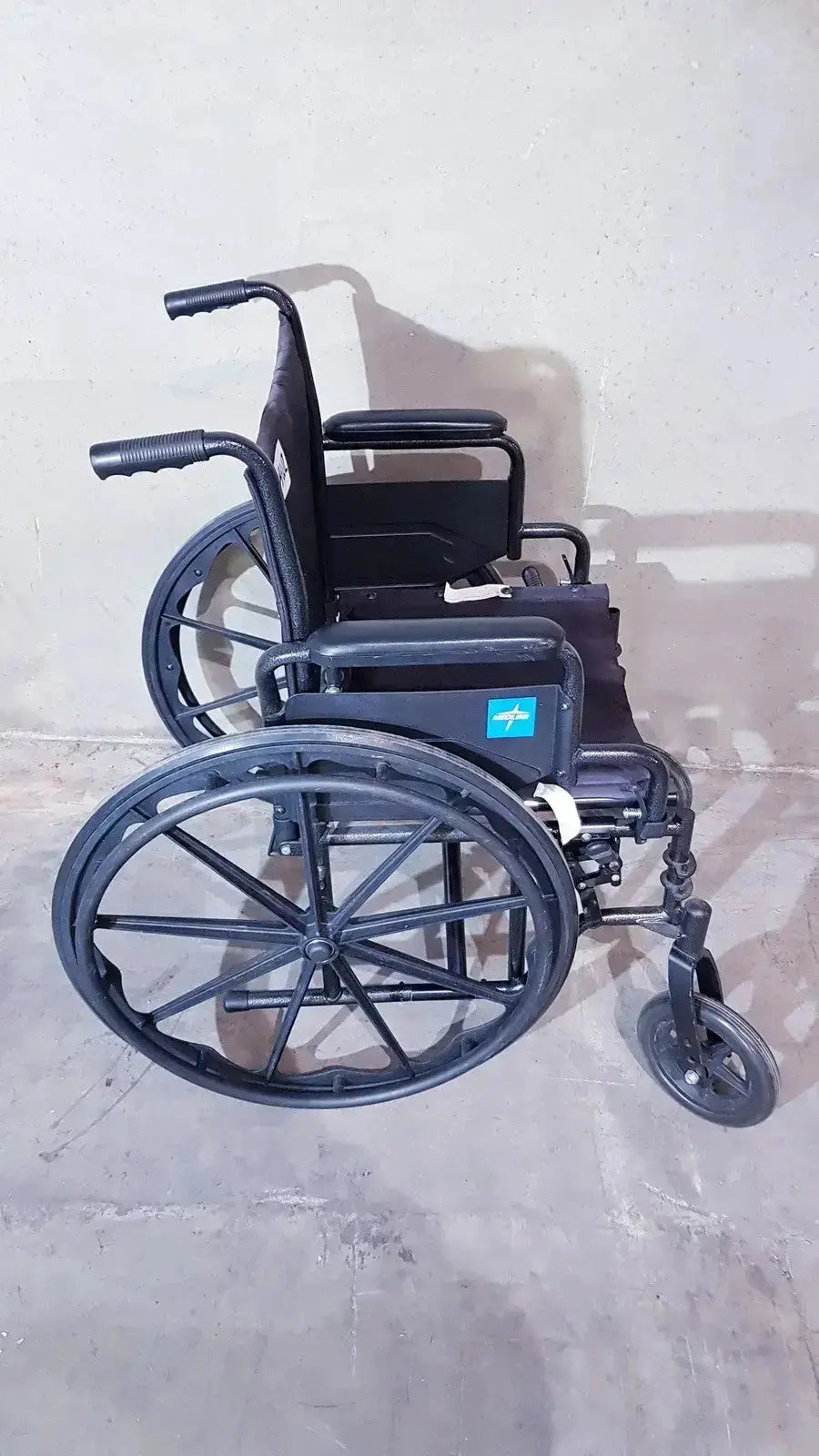 Black metal guardian k1 lightweight wheelchair compact seat with large rear wheels and padded backrest ready to use