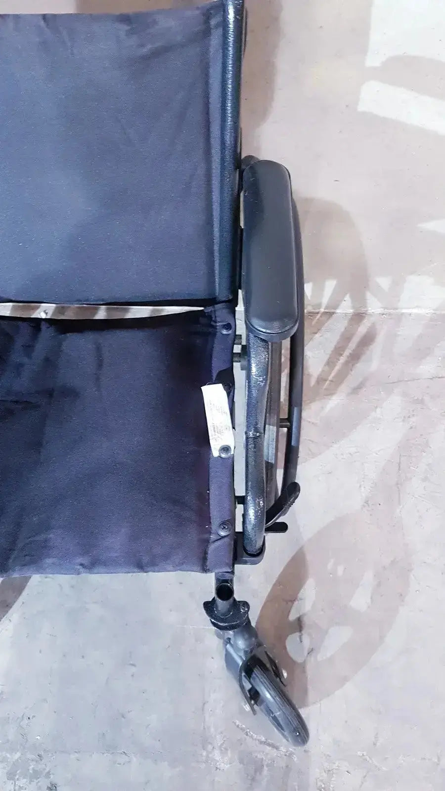Black fabric Medline Guardian K1 lightweight wheelchair compact seat with padded backrest and metal frame ready to use