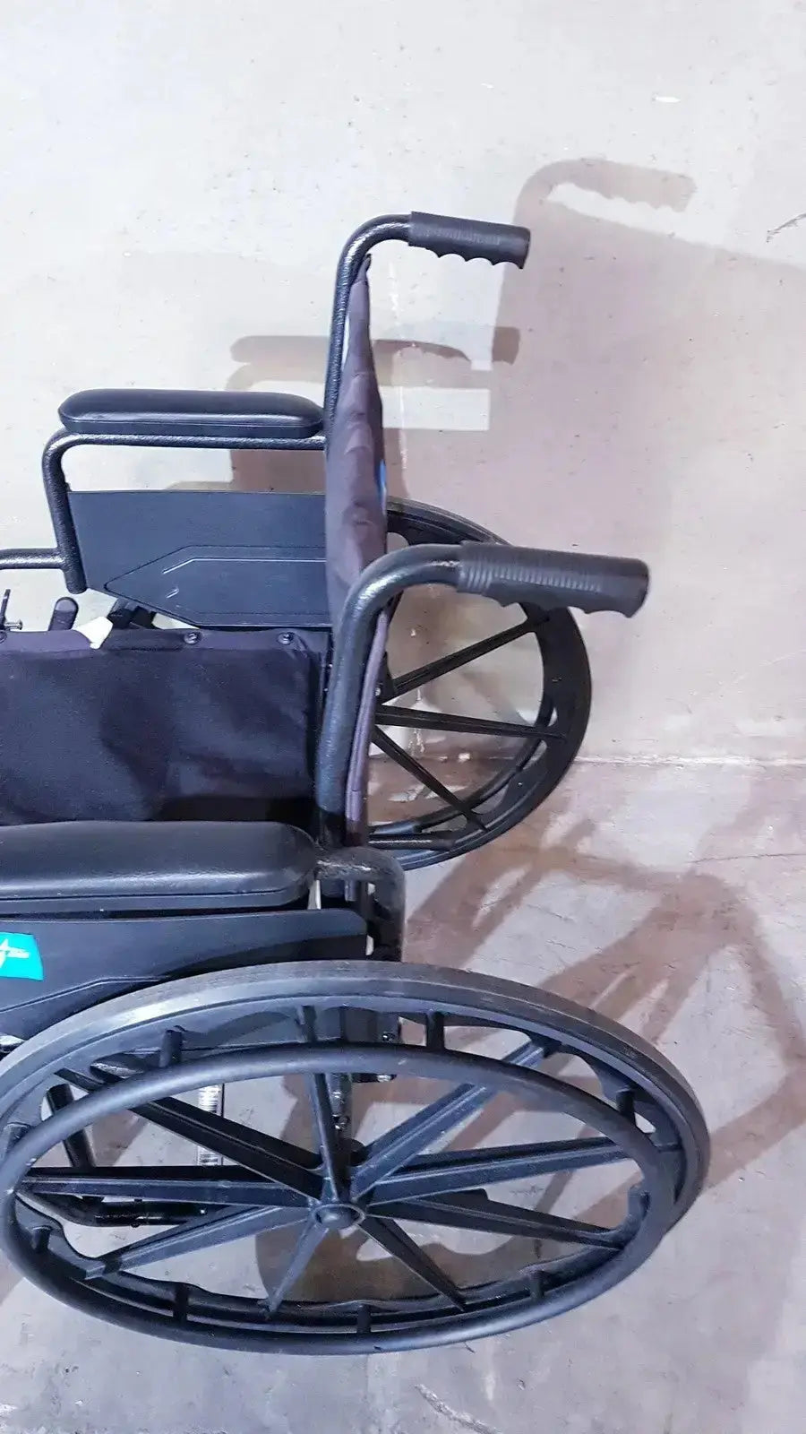 Black Medline Guardian K1 lightweight wheelchair compact seat with padded backrest and ergonomic handle grips