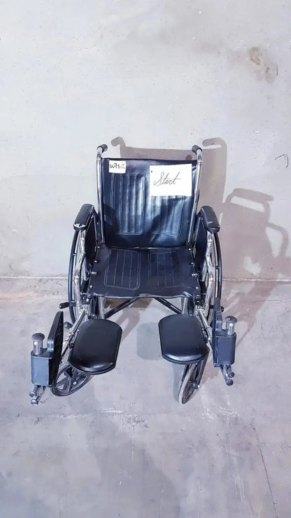 Black leather-backed medline k1206n22e manual wheelchair with metal frame and footrests shown from back side