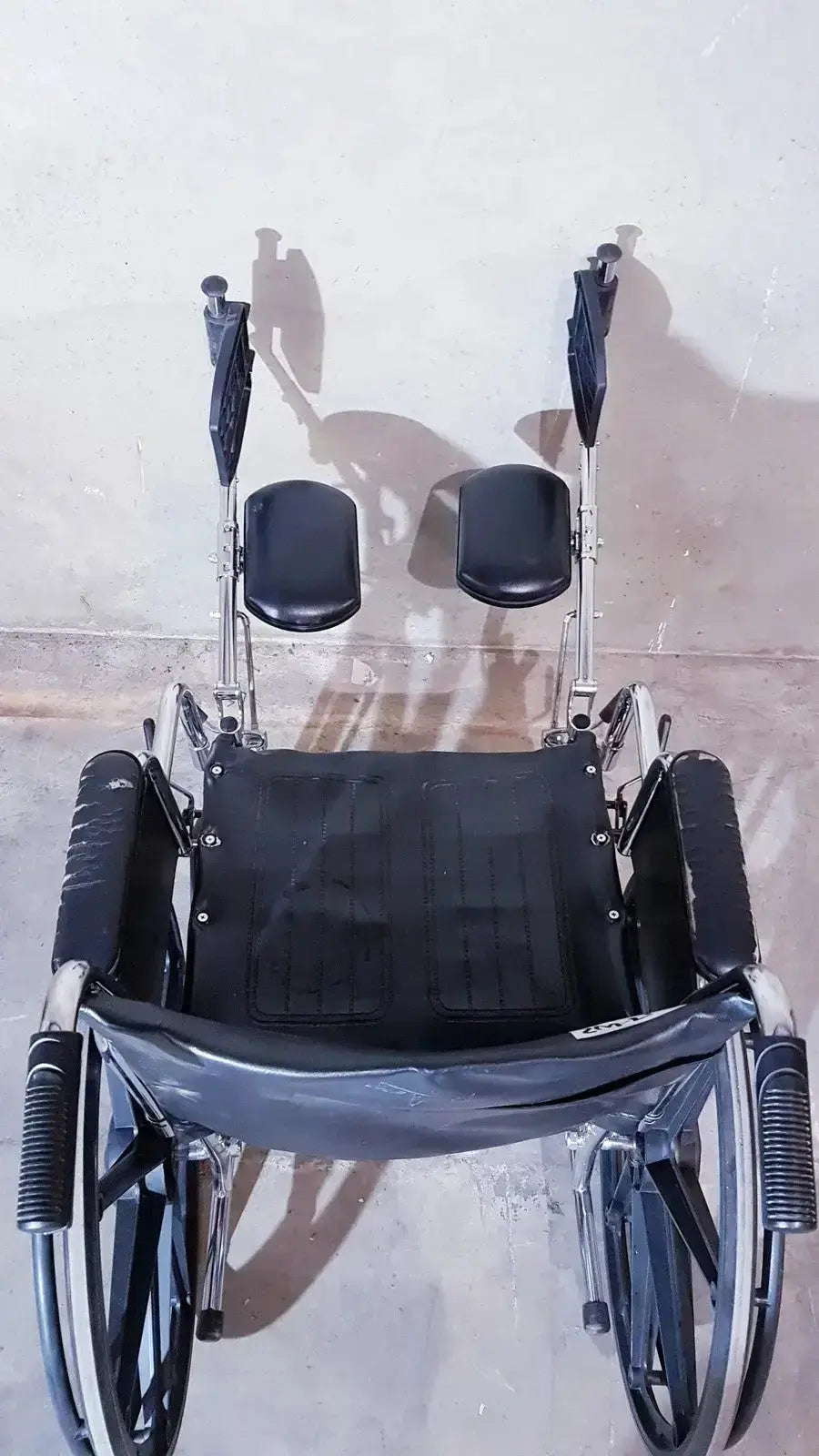Black medline k1206n22e manual wheelchair with silver metal frame and padded seat for adult use